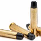 Four .45-70 Government 405gr RNFP Trapdoor cartridges displayed, ammunition designed for antique rifles and safe low-pressure shooting