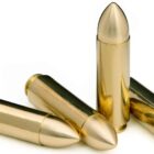 Four rounds of 12.7x42mm ammo with brass spike monolithic bullets on a white background