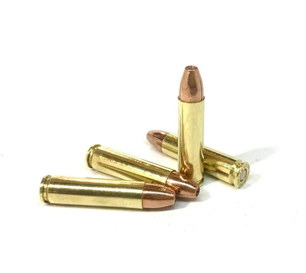 Four .30 Carbine 110gr solid copper hollow point rounds standing upright on a white background — modern SCHP ammo optimized for M1 Carbines, offering reliable expansion and performance for hunting and self defensive performance