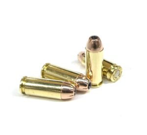 Four 10mm Auto 180gr jacketed hollow point cartridges standing upright on a white background — premium self-defense 10mm JHP ammo engineered for controlled expansion and deep penetration