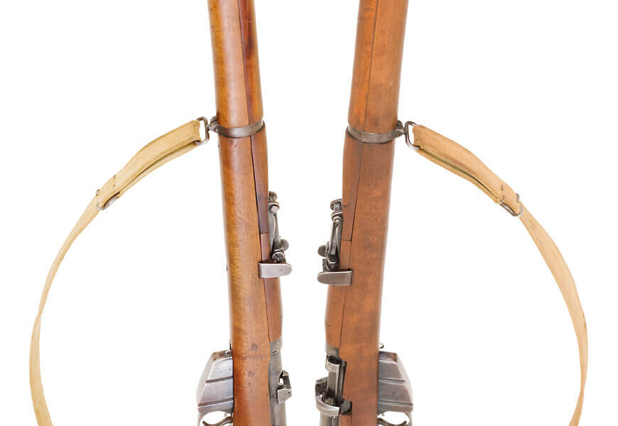 Two SMLE 303 British rifles standing side by side