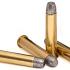 Four rounds of 45-70 Government 405gr RNFP Trapdoor Tradition ammunition arranged upright on a white background – classic black powder-era load ideal for antique Springfield Trapdoor rifles