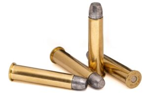 Four rounds of 45-70 Government 405gr RNFP Trapdoor Tradition ammunition arranged upright on a white background – classic black powder-era load ideal for antique Springfield Trapdoor rifles