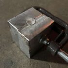 Crude prototype mold for 777gr Lucky Ram bullet—aluminum block clamped for casting trials in early development phase