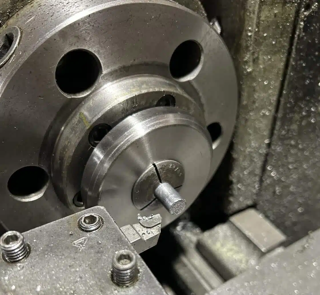 Machining 777gr Lucky Ram bullet prototype—turned on lathe using collet chuck, showing precision nose profiling in progress