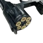 A blued Webley shim, loaded with 6 rounds, inserted into a revolver.