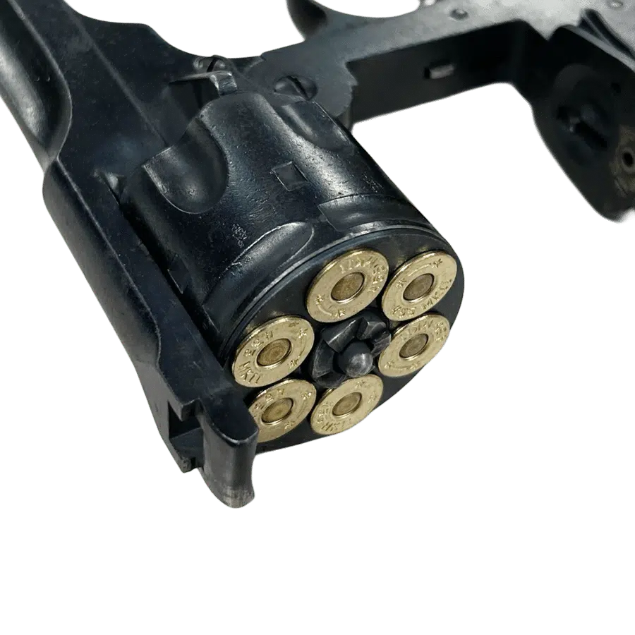 A blued Webley shim, loaded with 6 rounds, inserted into a revolver.