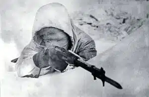 Finnish sniper Simo Häyhä, known as the “White Death” tracks a target over the open sights of his Mosin-Nagant rifle. Image Source: Warfare History Network[